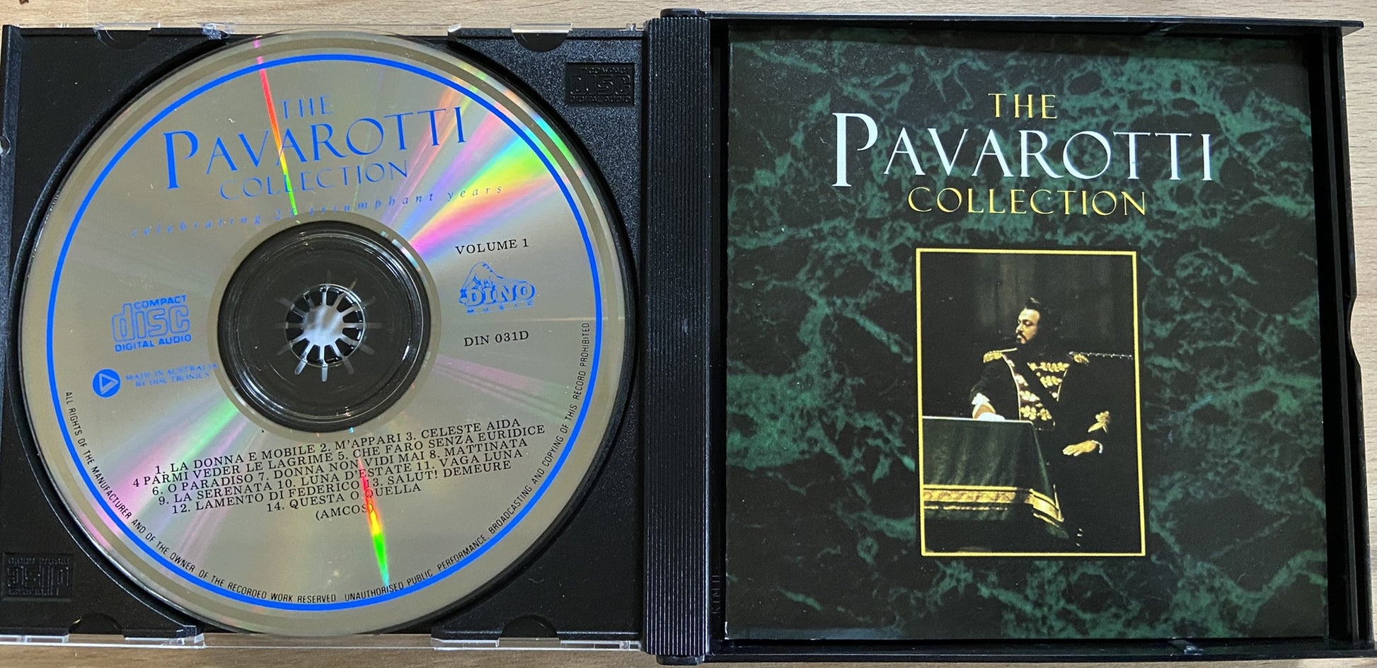 CD case with 'The Pavarotti Collection' on a green marble background
